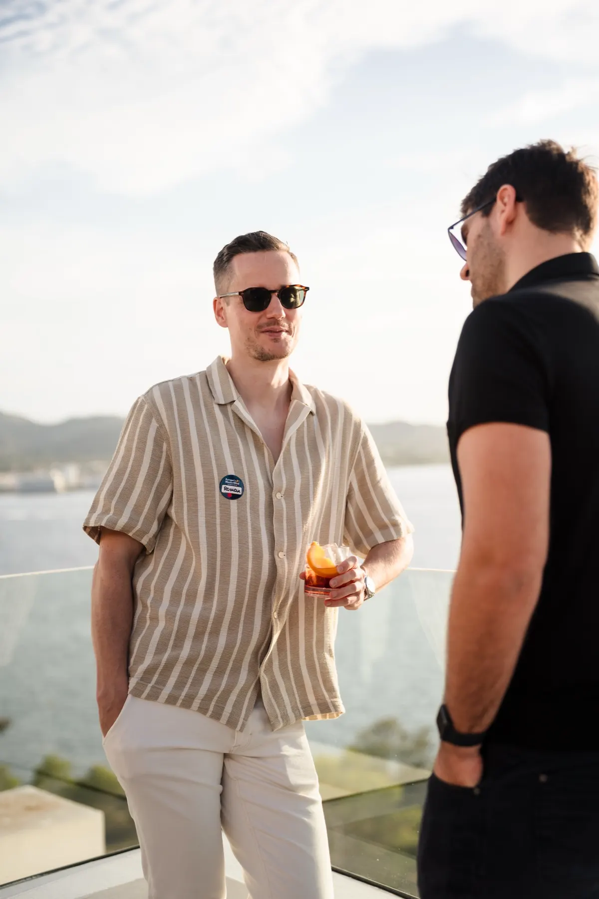 Zwei Männer im Gespräch mit Blick aufs Meer
